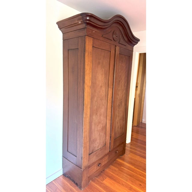 Bring home a stunning piece of 19th-century craftsmanship with this French antique walnut armoire, circa 1850. This grand...