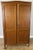 This elegant Vintage French Louis wardrobe displays a beautifully grained oak finish, refined panelled doors, and graceful...