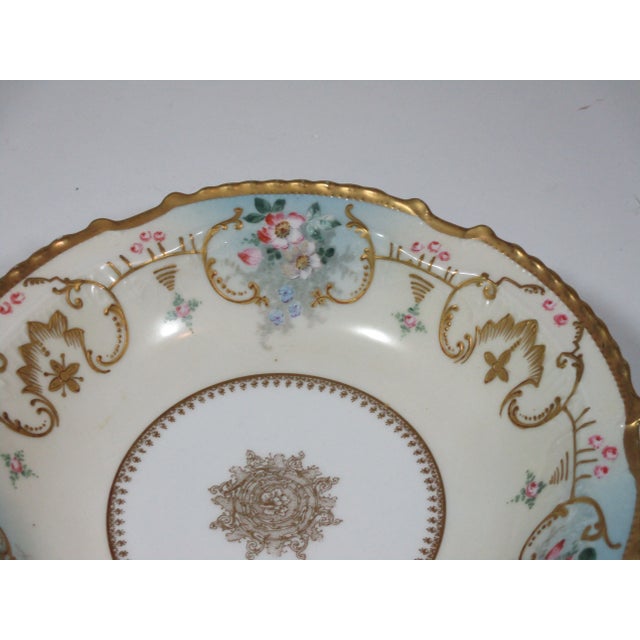 Hand painted Limoges France porcelain bowl. The bowl has a gold painted scalloped edge. The inside is decorated with...