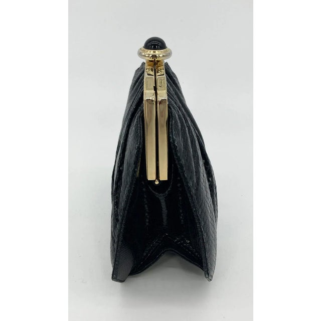 Judith Leiber Black Lizard Enamel Top Clutch in good vintage condition. Black lizard leather exterior trimmed with...