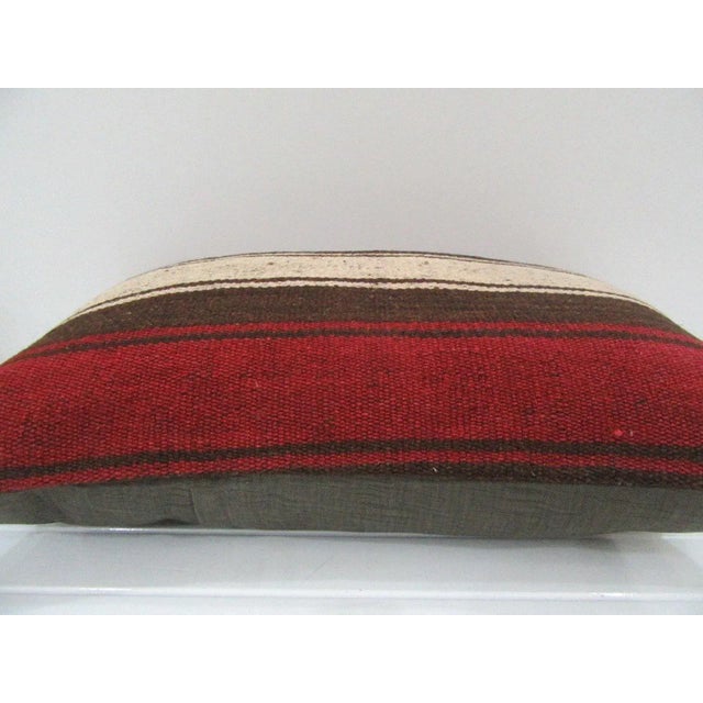 This is a pillow cover made from a vintage kilim rug. The piece was properly washed and ready to use. Pillow inserts not...