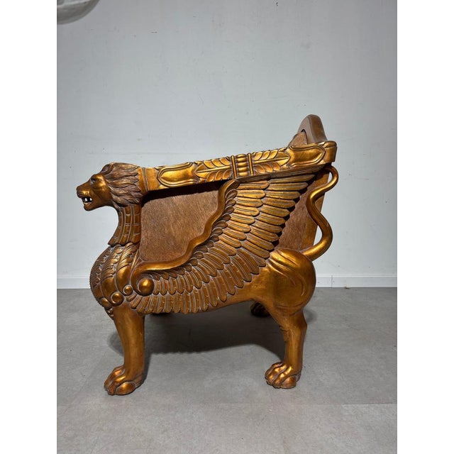 Command attention with this extraordinary throne-style armchair, a bold blend of ancient majesty and luxurious...