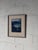This framed coastal landscape painting captures a moody seascape view with rich texture and depth. The expressive...