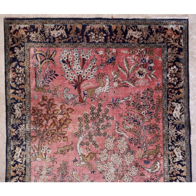 Pure silk rug, hand-knotted, very tightly, featuring deer and felines in their natural habitat. Fine, supple, and very...