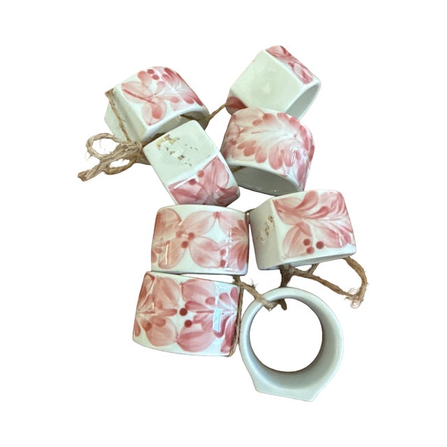A lovely set of eight vintage ceramic napkin rings with hand painted pink floral decoration. These pieces have a soft mid...
