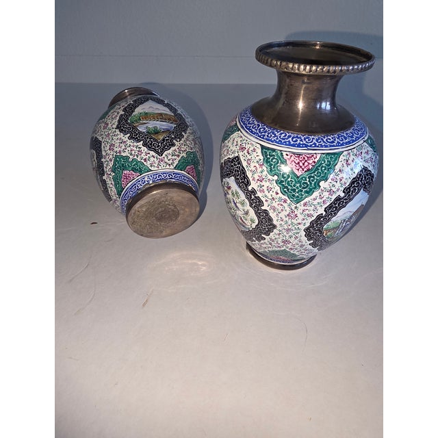 Pretty small pair of silver and enamel vases decorated with four scenes on each one surrounded with contrasting color...