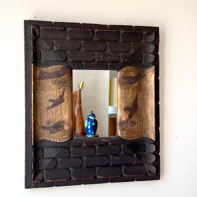 Vintage Chinoiserie style carved wood and burnished accent mirror. The wood is carved in an almost brick like pattern and...