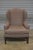 Description: Chairs feature a high back flanked by wings, rolled arms, single seat cushion resting on fluted legs with...