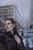 Bound by Stefan Smit | Oil on Panel Woman in a city street looking upwards on a rainy day. For Sale