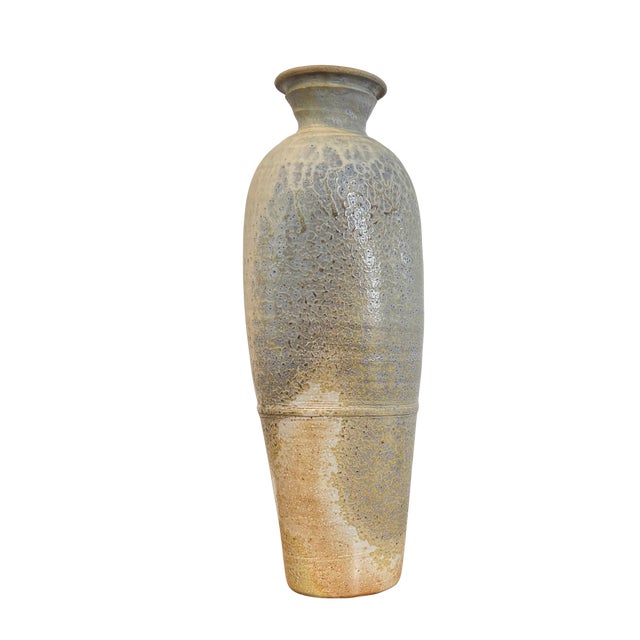 A tall, sculptural studio pottery vase finished in a beautifully restrained cool gray glaze with subtle tonal depth and...