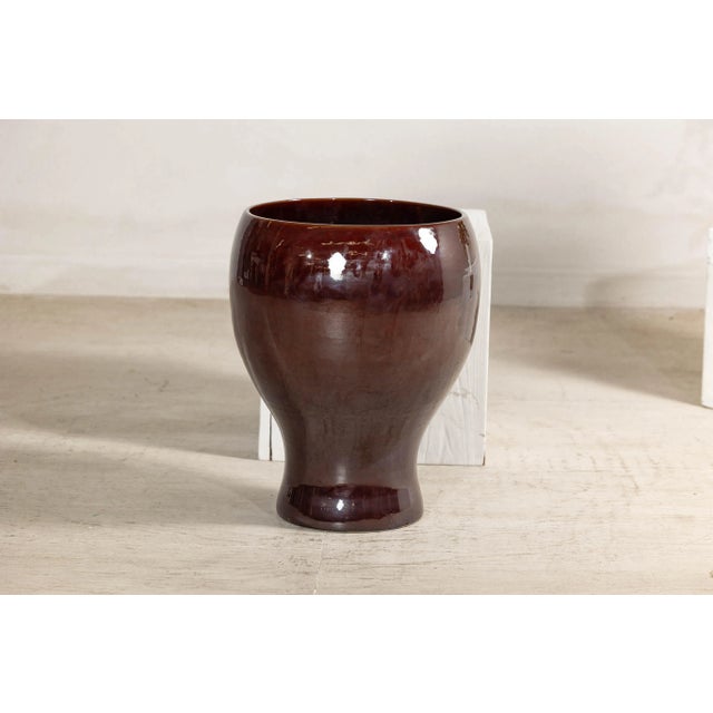 This large ceramic vessel features a striking reddish-brown glaze, rich in tone and evenly applied with a high-gloss...