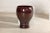 This large ceramic vessel features a striking reddish-brown glaze, rich in tone and evenly applied with a high-gloss...