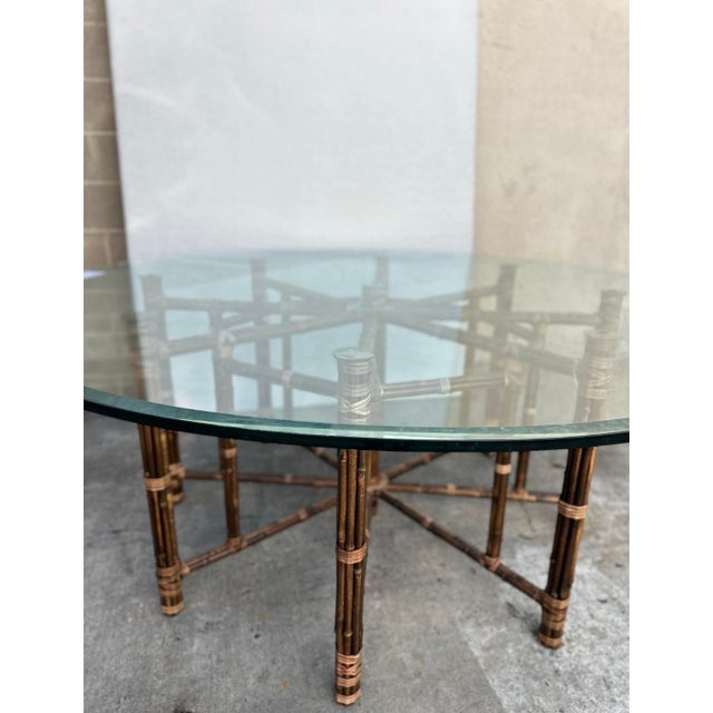 An exceptional large circular dining or center table by McGuire, circa 1980. Stout, heavy steel frame construction...