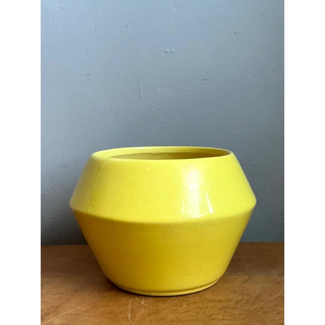 This vintage ceramic planter is shaped in a bold, faceted geometric form, with a wide, angular shoulder that tapers...