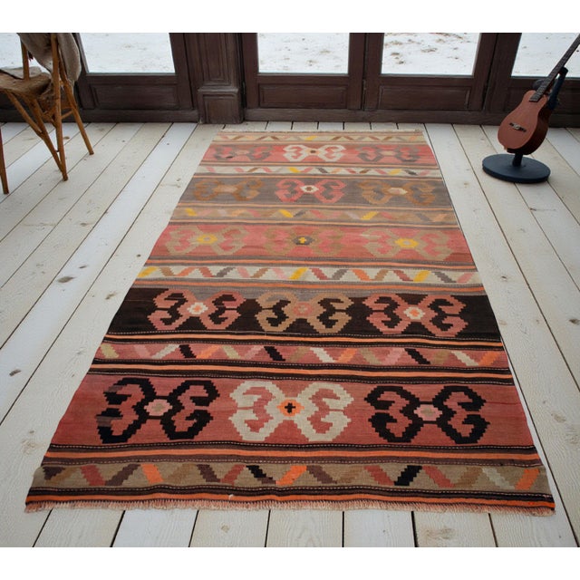 This authentic 1970s Kars kilim from Eastern Anatolia represents a significant departure from the region's typically...