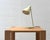 A distinctive table lamp by french designer robert caillat from the 1950s. The slender metal frame flows into a gently...