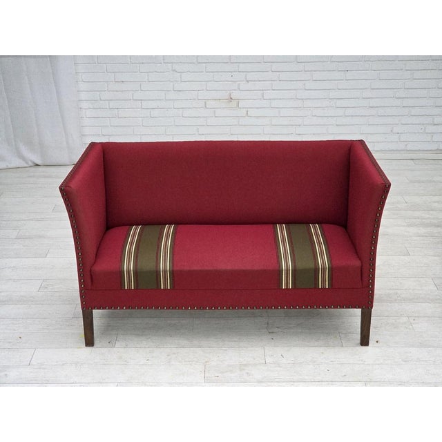 1970s, Danish 2-seater sofa. Original red furniture wool, ash wood legs, springs in the seat. Original very good...