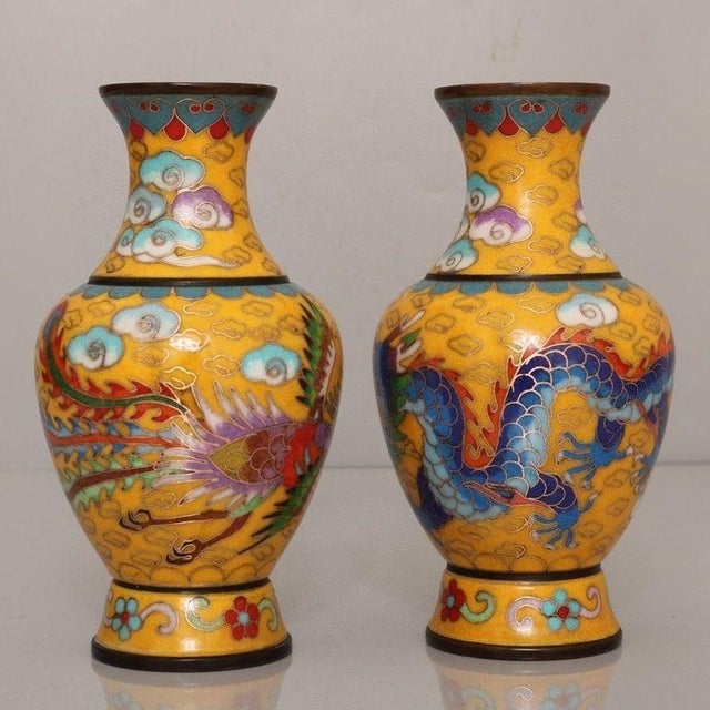 This striking pair of vintage cloisonne enamel vases features a classic baluster form with a flared rim and a bulbous...