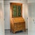 A two-piece, antique pine wood George III secretary bookcase with a green painted interior, glazed astral glass double...