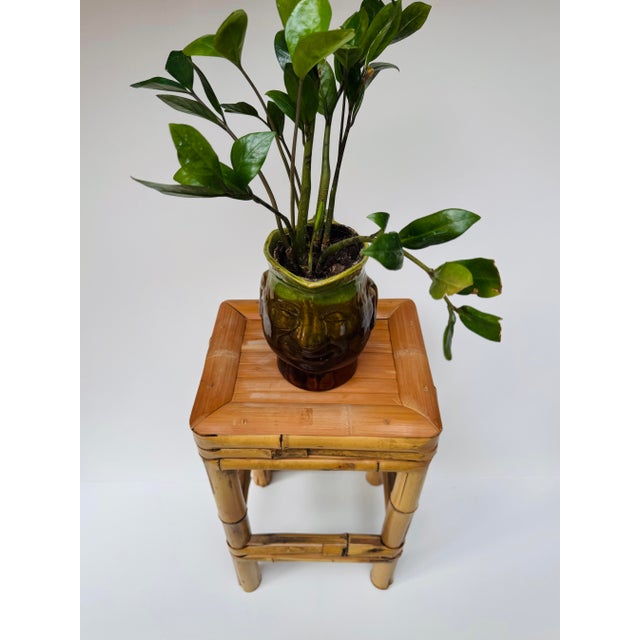 Vintage bamboo plant stand or small side table with a narrow rectangular form, slatted bamboo top, wrapped apron and lower...