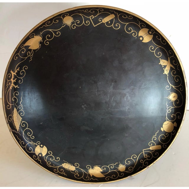 Japanese black lacquer pedestal plate is beautifully fashioned with a scalloped 3-leg base. Delicate floral gold details...