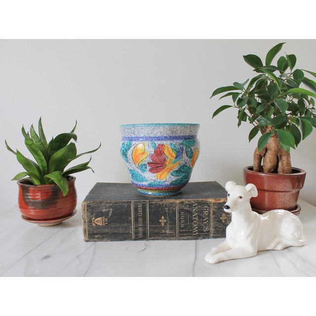 Mid-century Italian pottery planter features a hand-painted floral sgraffito design with vibrant red, yellow, and...