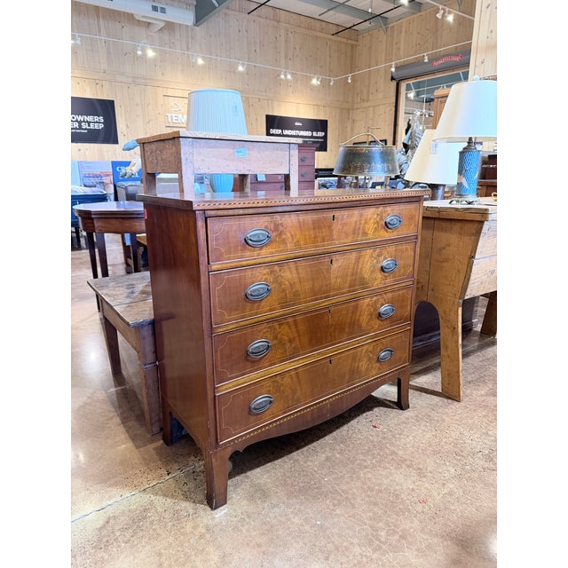 A distinguished early 19th century Federal style walnut chest, showcasing refined craftsmanship and a quietly commanding...