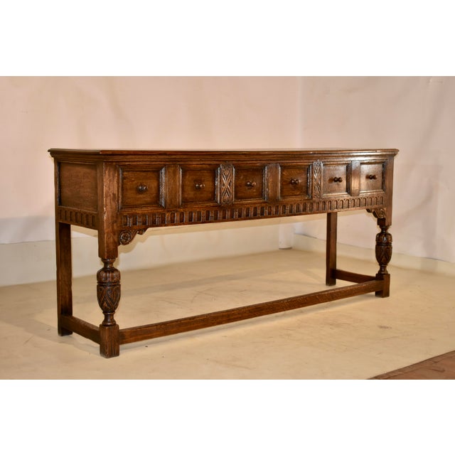 Circa 1900 period Edwardian oak sideboard from England. The top is richly grained and has a beveled and molded edge,...