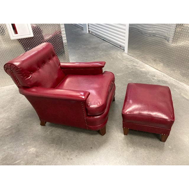 American Art Deco club chair and ottoman with walnut legs in red naugahyde, circa 1940s.