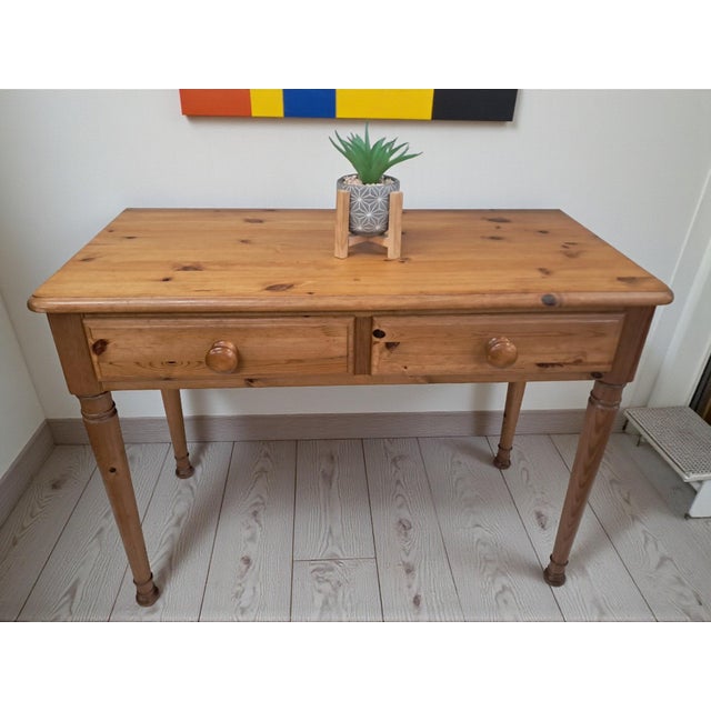 This solid pine console table by ducal is a well-crafted english piece dating from the 1980s, designed in a timeless...