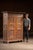 Tall two-door cupboard constructed of solid pine with a deeply worn painted surface and original hardware throughout. The...