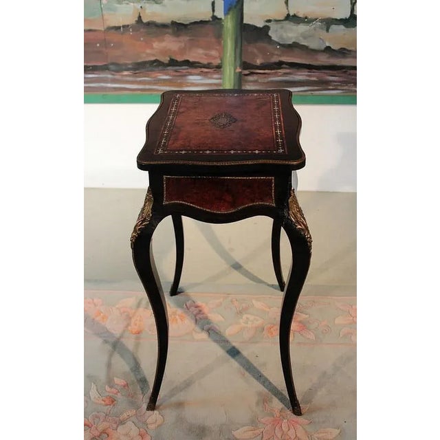 Louis xv style worker, in blackened wood, from the napoleon iii period. It rests on 4 curved legs decorated with bronzes....