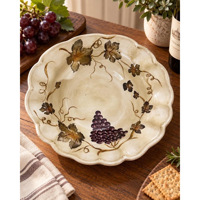 This charming hand-painted ceramic serving dish features a classic vineyard motif with rich purple grape clusters, green...