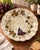 This charming hand-painted ceramic serving dish features a classic vineyard motif with rich purple grape clusters, green...