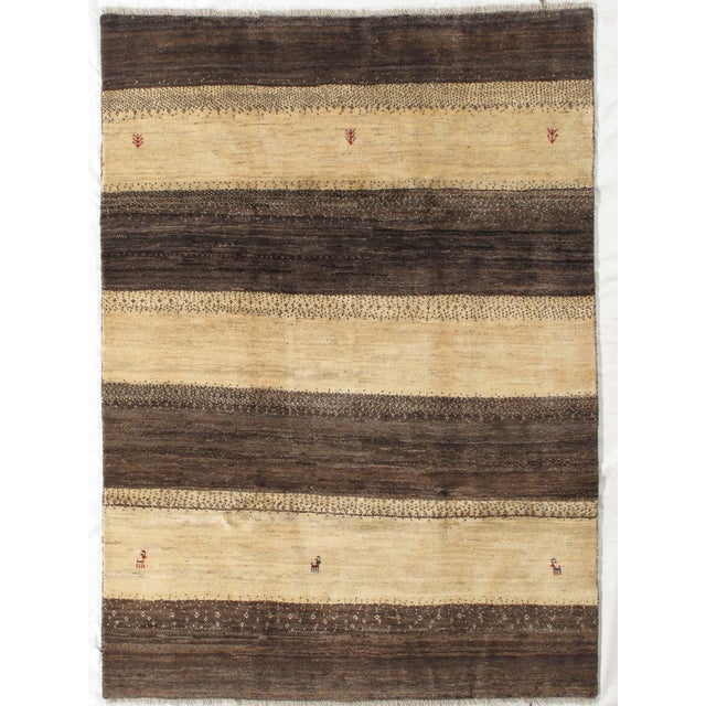 Vintage Hand-knotted Persian Lori Gabbeh rug featuring bold horizontal bands in rich brown and warm beige tones. The...