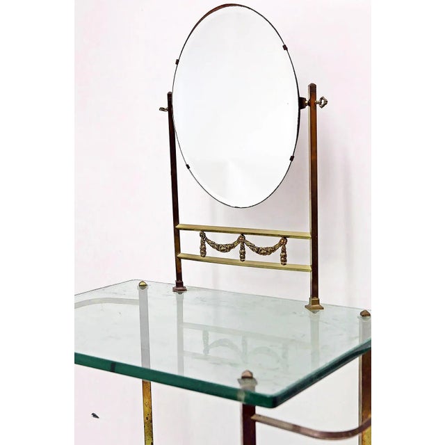 A unique French vintage glass vanity and washstand with beveled mirror framed in bronze and supported on brass legs. Heavy...