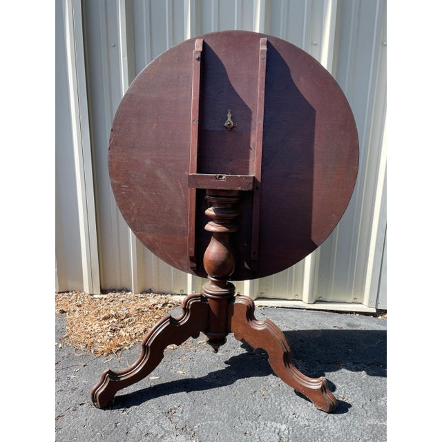 Antique solid mahogany tilt top table. Large in size, measures 36" in diameter. Decorative cabriole carved legs.