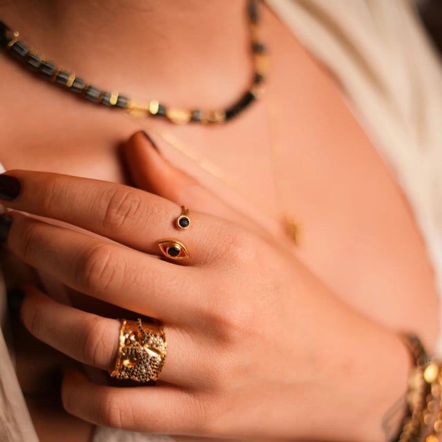 Spiritual Eye Black Onyx Stone & Gold Dainty Stackable Ring. The ring features a 24k gold-plated dainty band on brass,...