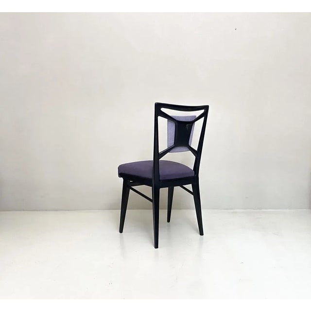 Group of 8 ebonized wooden dining chairs.