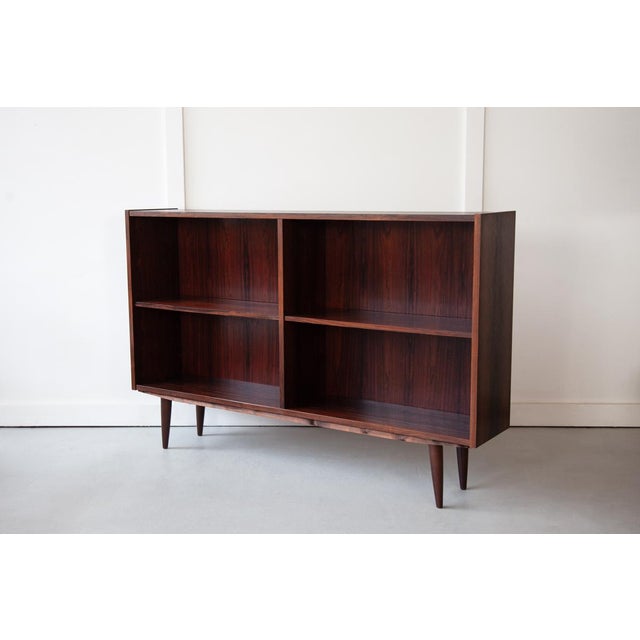 An elegant rosewood bookcase, made in Denmark in the 1960's, with adjustable shelves allowing them to be moved up and down...