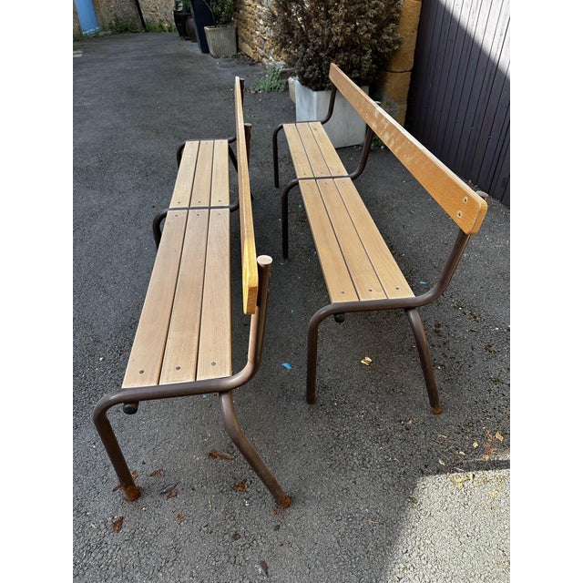Pair of stackable school benches in light wood and brown metal. Good overall condition, paint chipped on the legs.