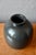 There is something profoundly seductive about this spherical vase: its black glaze with bluish and greenish reflections...