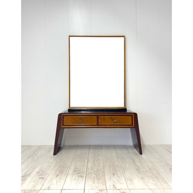 Wooden and walnut burl frame, brass details. Mirror with wooden frame and mirrored glass. 1950s Minor restorations This...