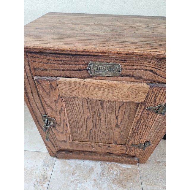 Early 20th century oak cabinet/ice box. Original brass hardware.