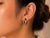 Estate 14K pink rose gold knot earrings featuring multi-color brilliant round diamonds. Each elegant earring is adorned...