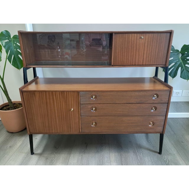 A refined and architectural nathan drinks cabinet dating from the mid-1960s, presented in exceptional vintage condition....