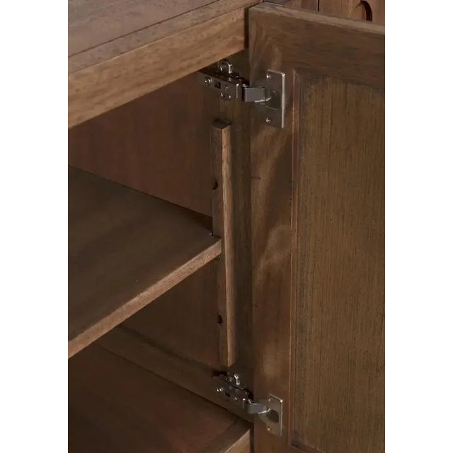 The Modea Sideboard combines refined elegance with functional design. Crafted from walnut and veneer with a rich dark...