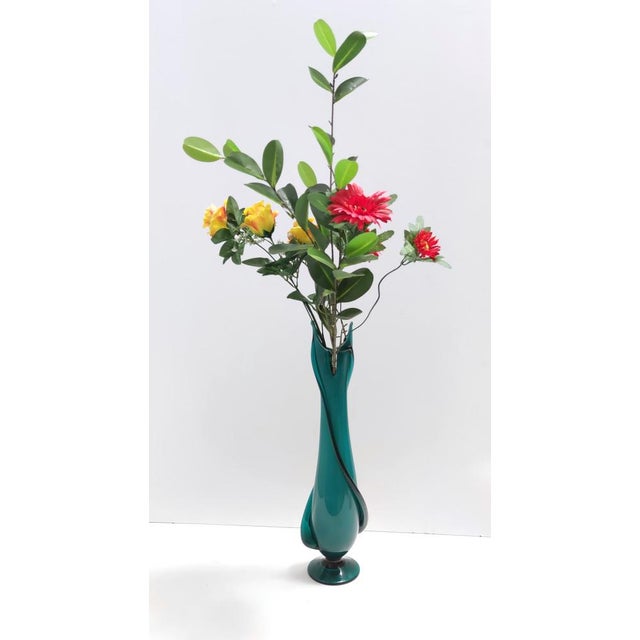 Made in Italy, 1960s. It is made in encased and hand-blown Murano glass. This vase is vintage, therefore it might show...