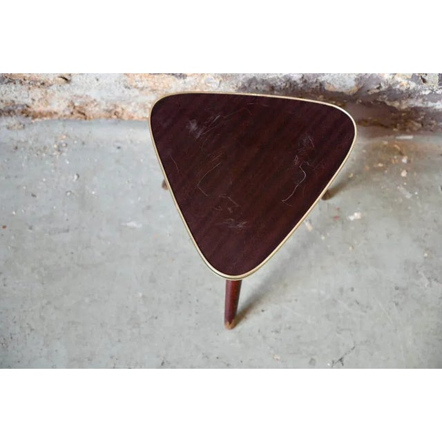 This is a small vintage pedestal table, simple and ultra-trendy. Exotic wood-style Formica top and compass tripod base in...