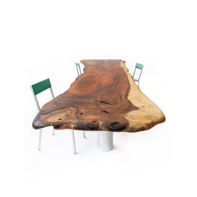 This brutalist dining table is designed by Deevie Vermetten for Fermetti. The Parota wooden top rests on 3 sanded aluminum...
